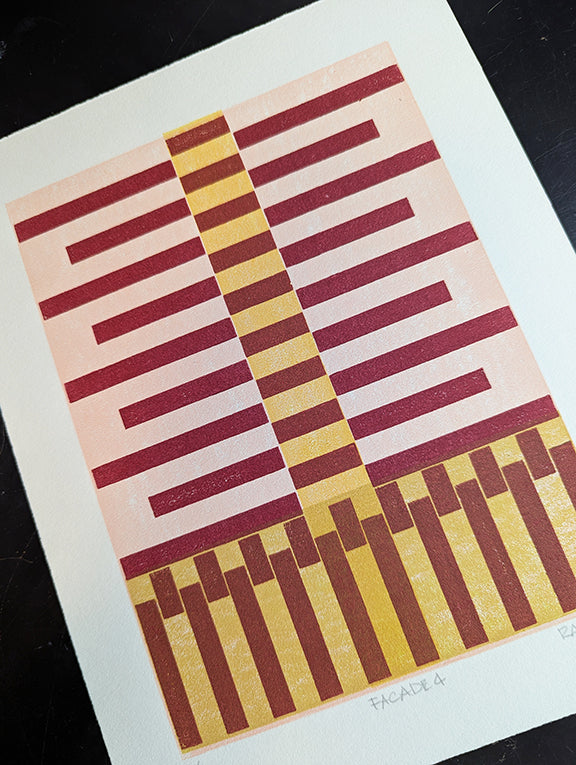 Geometric patterned print with red stripes on a pink and yellow background