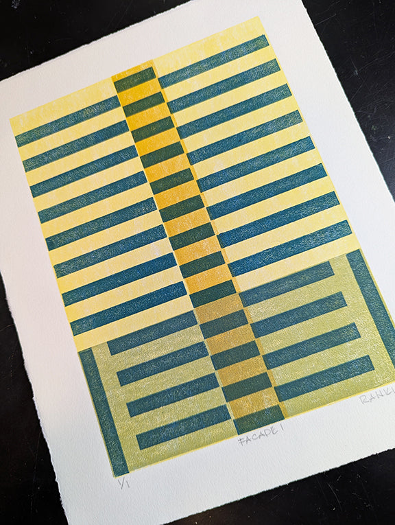 Geometric patterned print with teal and yellow stripes on a green and yellow background