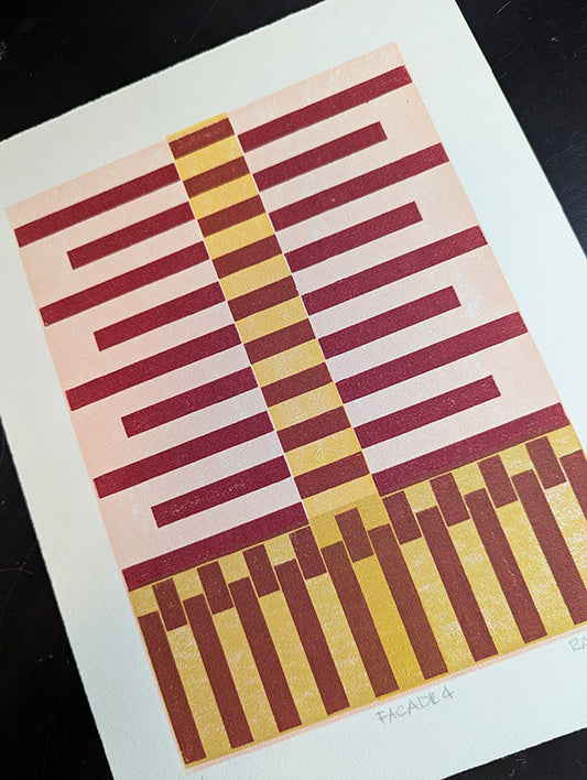 Geometric patterned print with red stripes on a pink and yellow  background